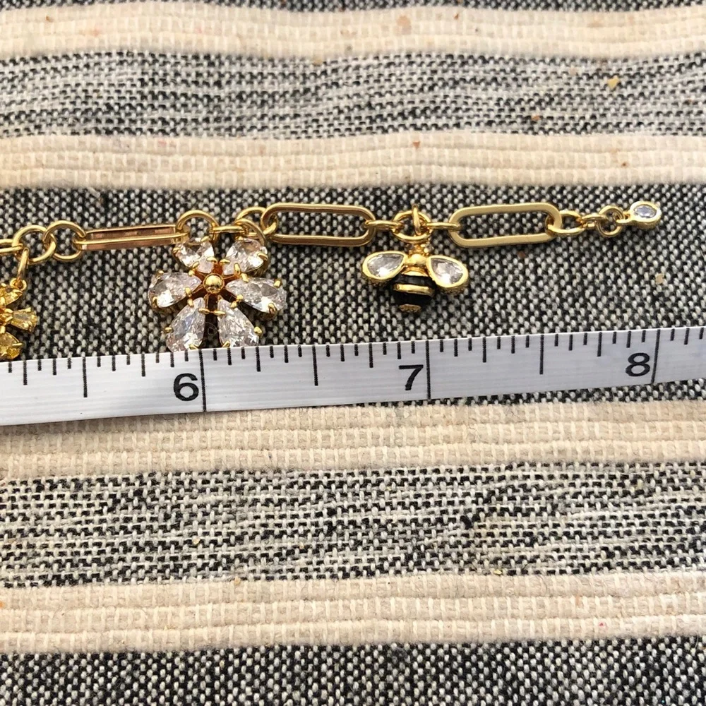 Authentic kate spade New with tag. Gold-Tone Crystal Flower & Bee Charm Bracelet